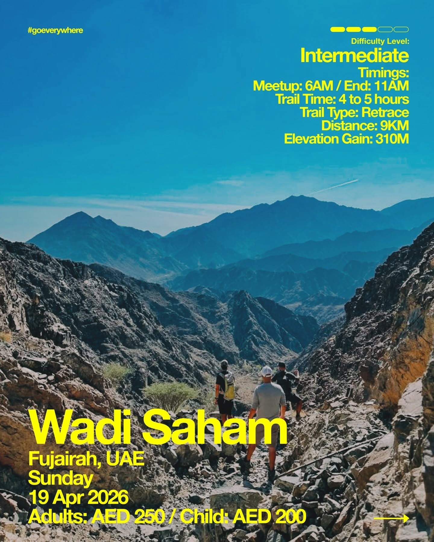 People hiking on rocky trail in Wadi Saham with mountain view, event details in yellow text above.